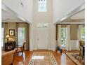 Grand two-story foyer featuring hardwood floors, transom windows, and elegant architectural details at 129 Willow Tree Ln, Mount Holly, NC 28120