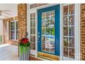 Inviting front door with glass panels, complemented by a stylish flower pot at 14426 Harvington Dr, Huntersville, NC 28078
