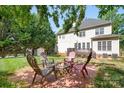 Serene backyard featuring a fire pit with seating, perfect for outdoor gatherings at 16028 Hallaton Dr, Huntersville, NC 28078