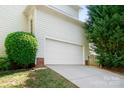 Attached two-car garage with a wide driveway, offering ample parking space at 16028 Hallaton Dr, Huntersville, NC 28078