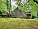 Charming brick home with well-maintained lawn, mature trees, and lush landscaping at 1623 Arbor Way, Albemarle, NC 28001