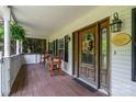 Cozy front porch with wooden chairs and a charming front door, enhancing the home's curb appeal at 1687 Windy Hill Ln, Great Falls, SC 29055