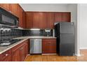 Efficient kitchen showcasing granite countertops, stainless steel appliances, and classic black cabinetry at 2125 Southend Dr # 448, Charlotte, NC 28203