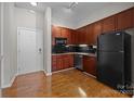 Efficient kitchen showcasing granite countertops, stainless steel appliances, and classic black cabinetry at 2125 Southend Dr # 448, Charlotte, NC 28203