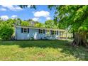 Beautiful blue home with a manicured lawn, complemented by black shutters and a bright yellow front door at 2313 Eleanor Dr, Shelby, NC 28150