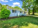 Lovely blue house featuring well-kept lawn, fresh mulch, and an inviting yellow front door at 2313 Eleanor Dr, Shelby, NC 28150