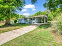Well-maintained blue house with a covered carport, a tidy lawn, and a welcoming yellow front door at 2313 Eleanor Dr, Shelby, NC 28150