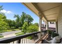 Inviting balcony with wicker furniture overlooking a serene tree-lined street at 2925 Westfield Rd, Charlotte, NC 28209