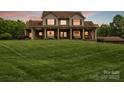 Charming two-story home with a welcoming front porch, decorative columns, and lush green lawn at 3440 17Th Ne Ave, Hickory, NC 28601