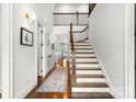 Bright foyer with hardwood floors, staircase, and wrought iron railing at 400 Hunter Ln, Charlotte, NC 28211