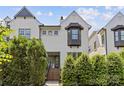 View of the home's exterior showing the upper level, with a dark-trimmed bay window and lush green landscaping at 4030 City Homes Pl, Charlotte, NC 28209