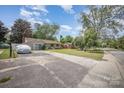Cozy home with a long driveway and a well-maintained front yard at 4100 Sudbury Rd, Charlotte, NC 28205