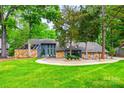 Beautiful home with stone accents, a green lawn, mature trees, and a welcoming driveway, creating a serene setting at 4609 Rounding Run Rd, Charlotte, NC 28277