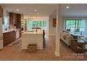 Open-concept kitchen with large island, modern appliances, and seamless flow to the living area at 50 Honeysuckle Woods, Lake Wylie, SC 29710
