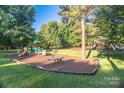 Community playground featuring multiple play structures, slides, and swings for enjoyment at 50 Honeysuckle Woods, Lake Wylie, SC 29710