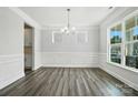 Open-concept living room with gray flooring, white walls, and bright windows at 5103 Heathland Dr # 50, Charlotte, NC 28215
