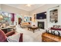 Inviting living room featuring fireplace, built-in shelving, and open layout at 534 Ballymote Ct, Matthews, NC 28104