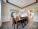 Elegant dining room featuring wood table and designer lighting at 6004 Quintessa Dr, Matthews, NC 28104
