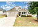 Charming single-Gathering home with a two-car garage, covered porch, and manicured lawn at 7113 Meridale Forest Dr, Charlotte, NC 28269