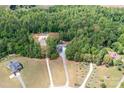 Stunning aerial view of the property surrounded by lush greenery, showcasing its spacious layout and privacy at 720 Cricket Ln, Mt Ulla, NC 28125