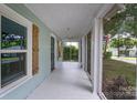 Inviting screened-in porch with white floors and plenty of natural light at 917 Laye St, Belmont, NC 28012