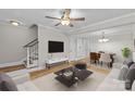 A bright living room with hardwood floors, modern furniture, and a ceiling fan at 1228 Archdale Dr # H, Charlotte, NC 28217