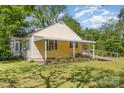 Quaint single-story home with a ramp providing accessibility to the front porch and a serene outdoor space at 1302 N Ellis St, Salisbury, NC 28144