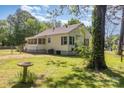 Charming single-story home with a screened porch and a well-maintained yard, exuding a cozy and inviting ambiance at 1302 N Ellis St, Salisbury, NC 28144