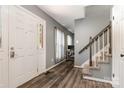 Welcoming foyer with hardwood floors, a staircase, and a view into an office space at 131 Scotland Dr, Mooresville, NC 28115