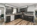 Modern kitchen with black cabinetry, stainless steel appliances, granite countertops, and tile backsplash at 131 Scotland Dr, Mooresville, NC 28115