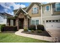 Beautifully landscaped front yard and stone accents adorn this charming home at 14837 Dungannon Ct, Charlotte, NC 28278