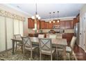 Kitchen with wood cabinets, granite countertops, pendant lighting, and stainless steel appliances at 14837 Dungannon Ct, Charlotte, NC 28278