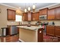 Modern kitchen featuring an island, stainless steel appliances, and granite countertops at 14837 Dungannon Ct, Charlotte, NC 28278