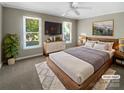 Cozy bedroom with large windows, ceiling fan, and stylish furnishings at 1507 Chadmore Nw Ln, Concord, NC 28027
