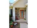 Cozy front porch featuring stone accents, a wooden door, and decorative plants for added charm at 1657 6Th Se St, Hickory, NC 28602