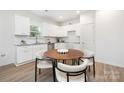 Eat-in kitchen featuring white cabinets, granite counters, and stainless steel appliances at 220 S Columbia St, Gastonia, NC 28054