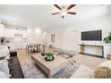 Spacious living room featuring modern furniture, ceiling fan and open layout to the kitchen at 220 S Columbia St, Gastonia, NC 28054