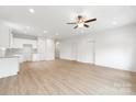Spacious, open-concept area features modern light fixture, ceiling fan, wood-look flooring, and an eat-in kitchen at 220 S Columbia St, Gastonia, NC 28054