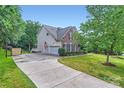 Side exterior view with a basketball hoop and a spacious driveway at 2215 Maycroft Dr, Charlotte, NC 28262