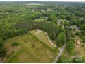An aerial view of the home and property showcasing the lush landscaping and wooded acreage at 2609 Cove Creek Dr, Gastonia, NC 28056