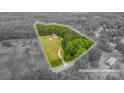 An aerial view with approximate lot lines around the property, showing wooded acreage at 2609 Cove Creek Dr, Gastonia, NC 28056