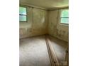 Empty bedroom with carpeted floor, needing renovation with wood trim pieces ready for installation at 2703 E Greenbriar Rd, Statesville, NC 28625