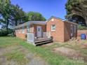 Charming, single-story brick home features a quaint front porch and well-maintained lawn on a sunny day at 303 Island Ford Rd, Maiden, NC 28650