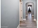 Elegant hallway featuring hardwood floors, arched doorways, and neutral paint at 303 Island Ford Rd, Maiden, NC 28650