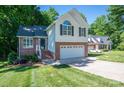 Well-kept two-story home with brick and siding, attached garage, and a neatly manicured front lawn at 319 Beacon Hills Dr, Gastonia, NC 28056