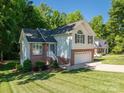 Beautiful two-story house has an attached garage, brick and siding accents, and a lush green lawn at 319 Beacon Hills Dr, Gastonia, NC 28056