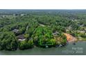 Stunning aerial view of a waterfront property surrounded by lush greenery, showcasing its private dock and serene lakeside setting at 4647 16Th Street Ne Pl, Hickory, NC 28601
