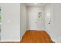 Bright foyer with hardwood floors, white doors, and neutral wall paint at 5028 Polo Gate Blvd, Charlotte, NC 28216