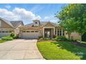 Charming single-Gathering home boasts a stone and siding exterior, well-manicured lawn, and a two-car garage at 5028 Polo Gate Blvd, Charlotte, NC 28216