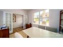 Bright home office with French doors, neutral decor, and a large window offering ample natural light at 545 Stroupe Rd, Gastonia, NC 28056